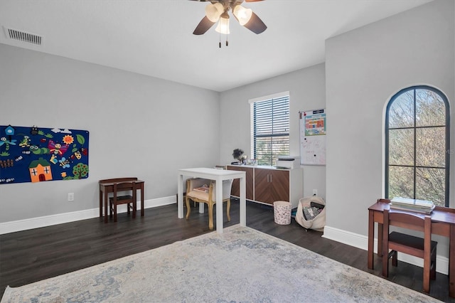 office space featuring dark hardwood / wood-style flooring and ceiling fan