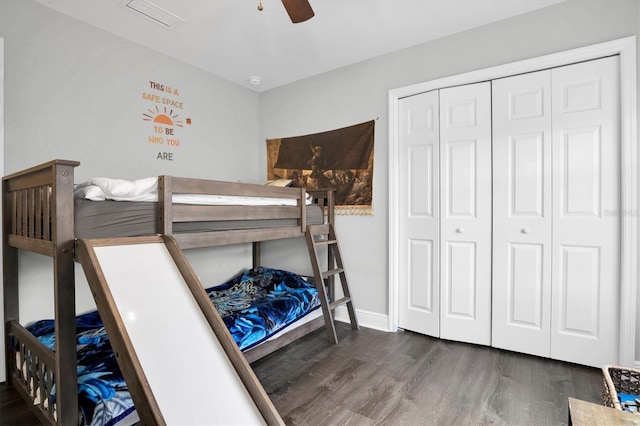 bedroom featuring ceiling fan, dark hardwood / wood-style flooring, and a closet