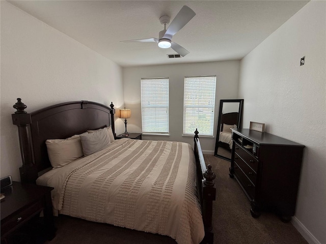 bedroom with dark colored carpet and ceiling fan