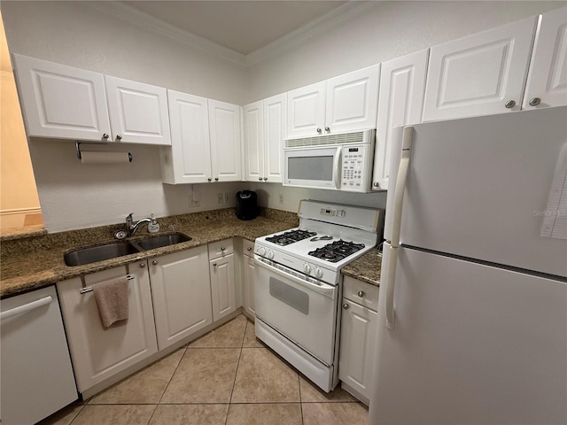 kitchen with white appliances, crown molding, sink, light tile patterned flooring, and white cabinetry