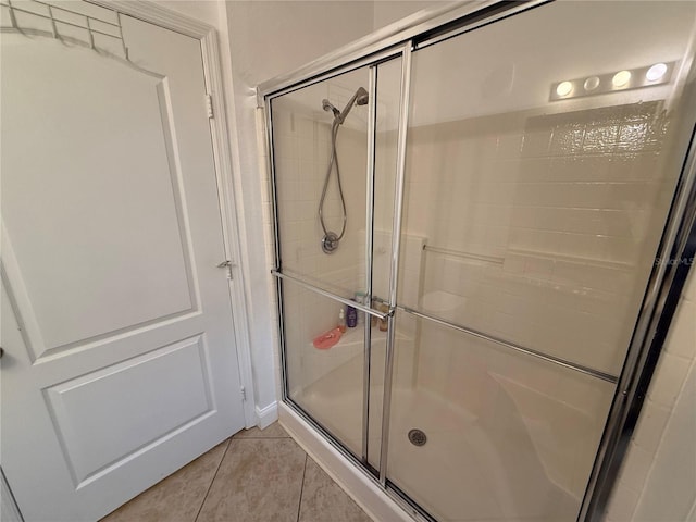 bathroom with tile patterned floors and walk in shower