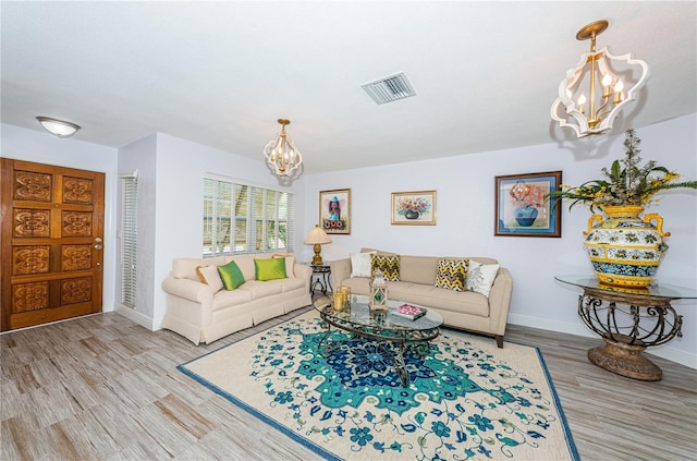 living room with hardwood / wood-style floors and a chandelier