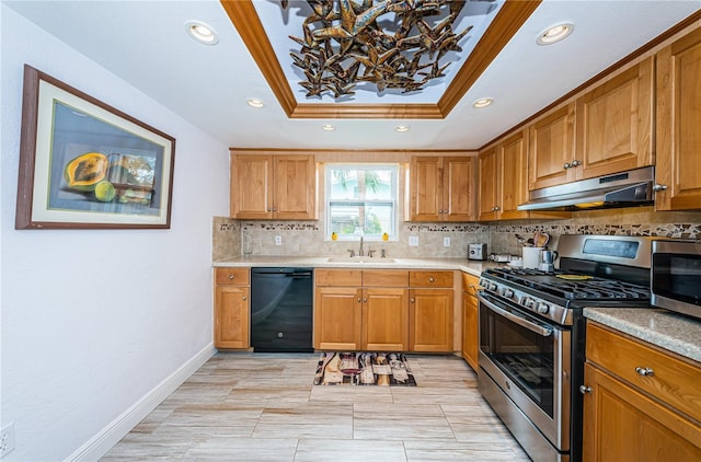 kitchen with backsplash, stainless steel appliances, a tray ceiling, crown molding, and sink