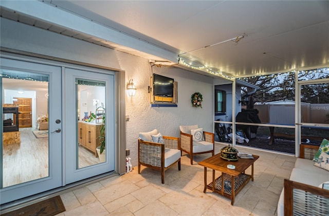 sunroom / solarium featuring french doors