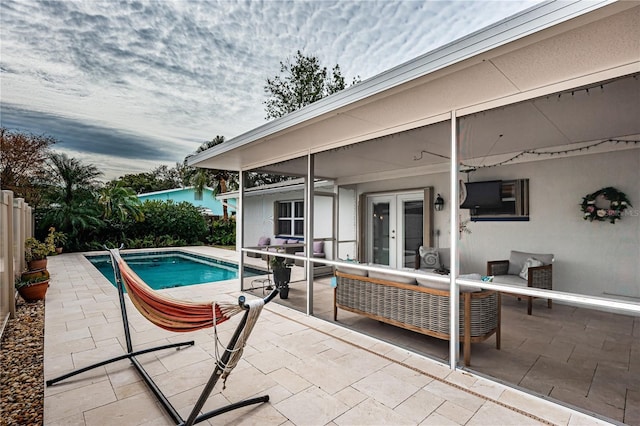 view of pool featuring french doors, an outdoor living space, and a patio area