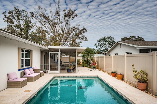 view of pool with a patio area and a sunroom