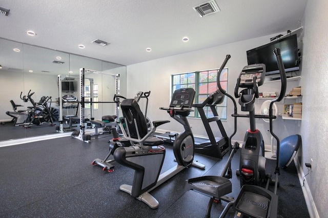 gym with a textured ceiling