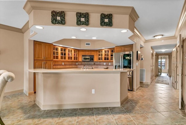 kitchen with tasteful backsplash, sink, a center island with sink, and appliances with stainless steel finishes