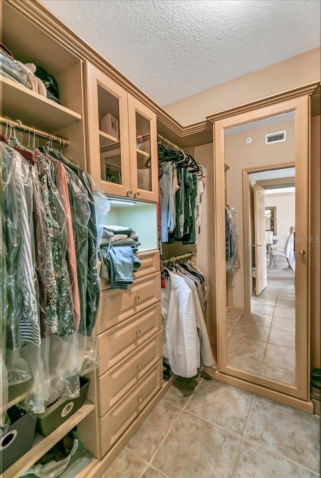 spacious closet featuring light tile patterned flooring