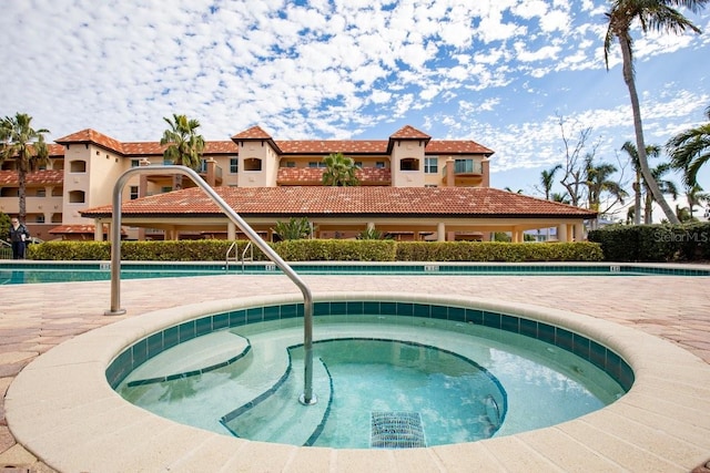 view of pool featuring a community hot tub