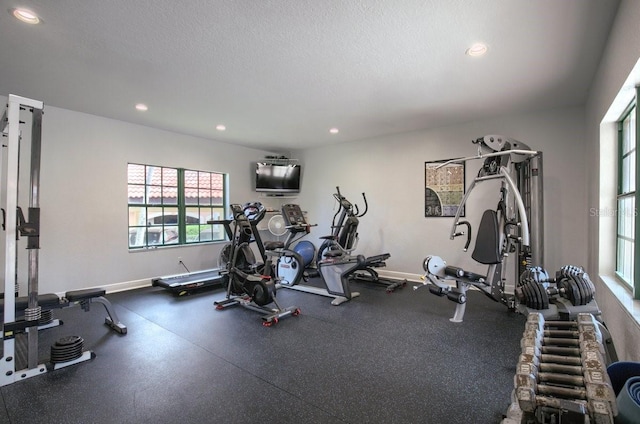 exercise room with a textured ceiling