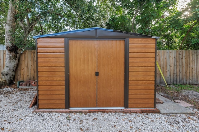 view of shed with a fenced backyard