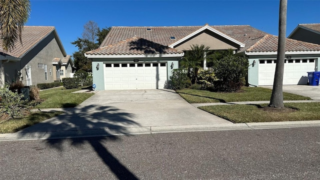 view of front of property featuring a garage and a front yard