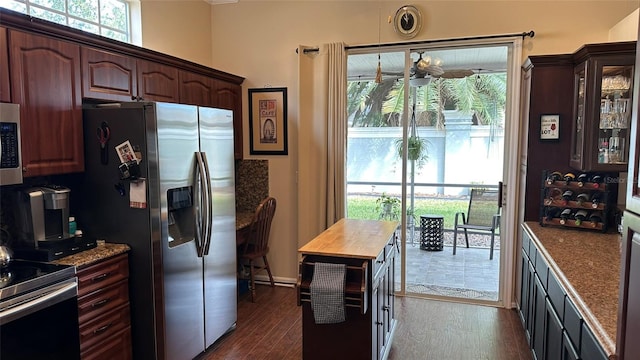 kitchen with dark brown cabinetry, appliances with stainless steel finishes, and dark hardwood / wood-style floors