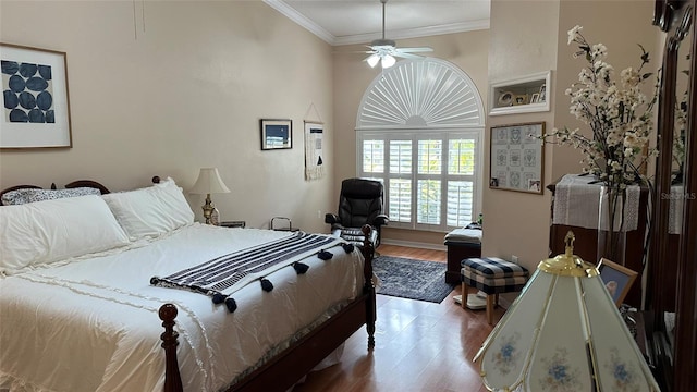 bedroom with ceiling fan, hardwood / wood-style flooring, and crown molding