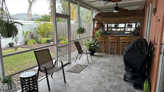 sunroom featuring ceiling fan