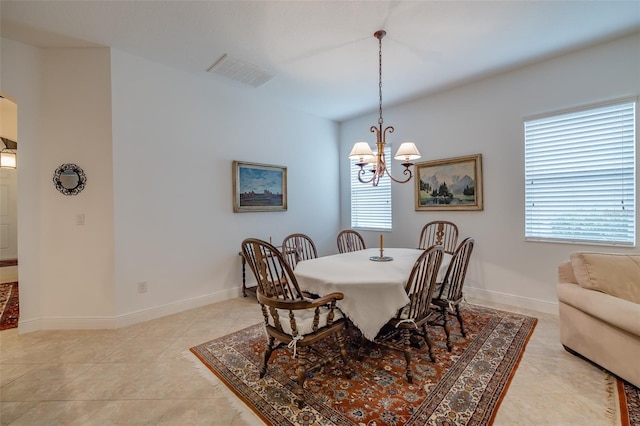 dining room with a notable chandelier and light tile patterned floors