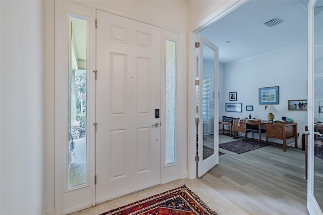 entryway with light hardwood / wood-style flooring and a wealth of natural light