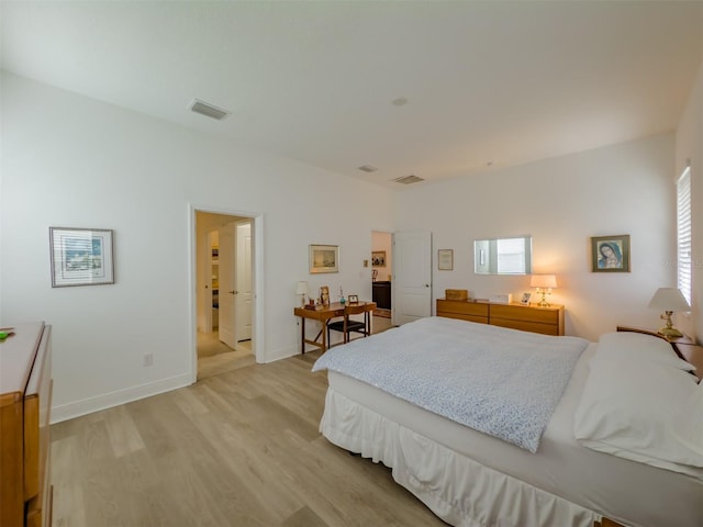 bedroom with light wood-type flooring and multiple windows