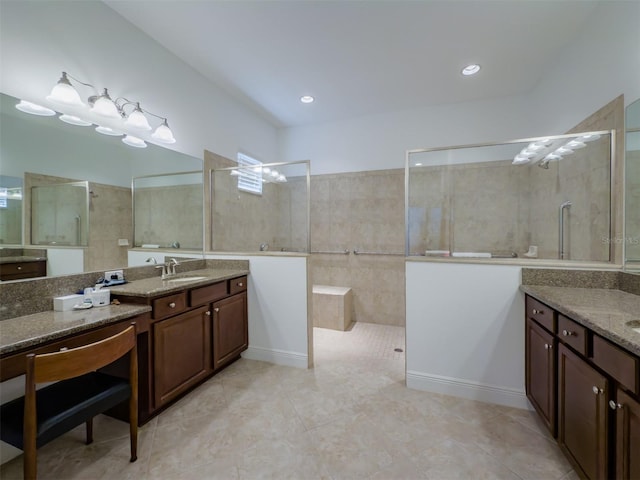 bathroom with a tile shower, tile patterned floors, and vanity