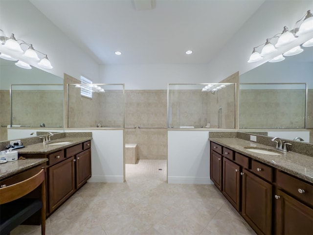 bathroom featuring a tile shower, tile patterned floors, and vanity