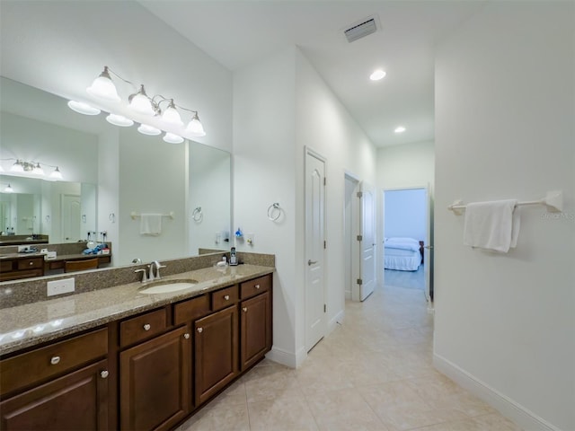 bathroom featuring tile patterned flooring and vanity