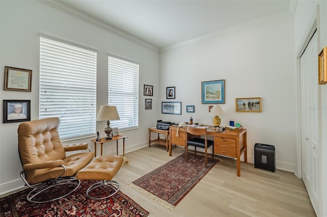 office area with ornamental molding and light hardwood / wood-style flooring