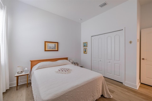 bedroom with light hardwood / wood-style flooring and a closet