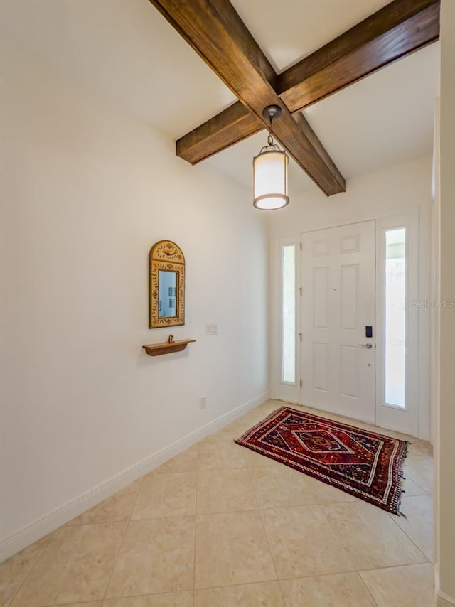 tiled foyer featuring beamed ceiling