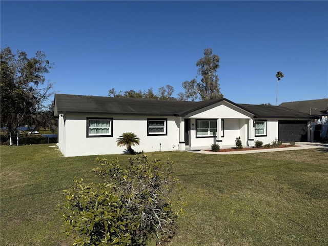 ranch-style house with a front yard and a garage