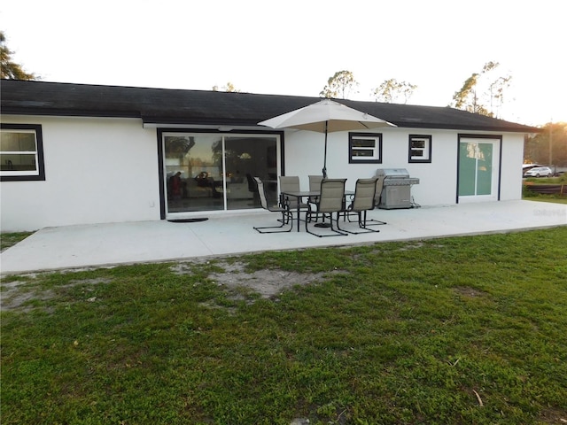 rear view of property with a patio area and a lawn