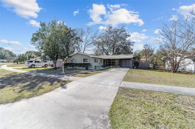 ranch-style house with a carport and a front lawn