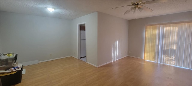 unfurnished living room featuring ceiling fan, a textured ceiling, and light wood-type flooring