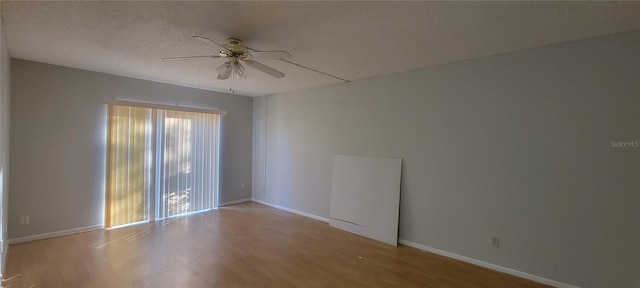 empty room with wood-type flooring, a textured ceiling, and ceiling fan