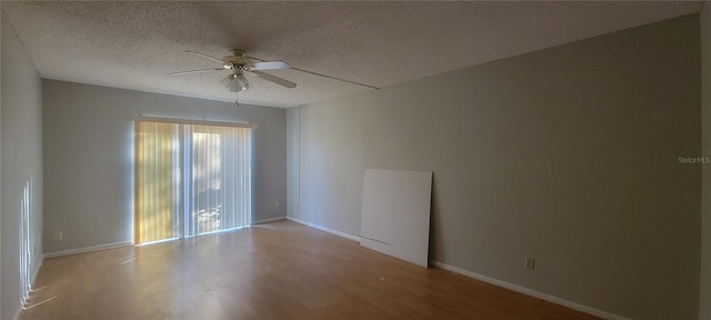 empty room with ceiling fan, a textured ceiling, and light wood-type flooring