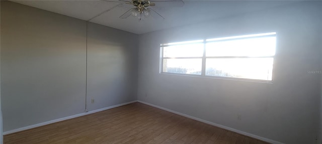 spare room with hardwood / wood-style flooring and ceiling fan