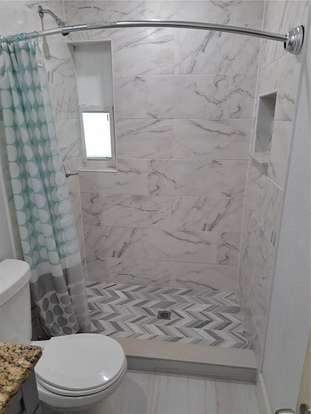 bathroom with toilet, walk in shower, and vanity