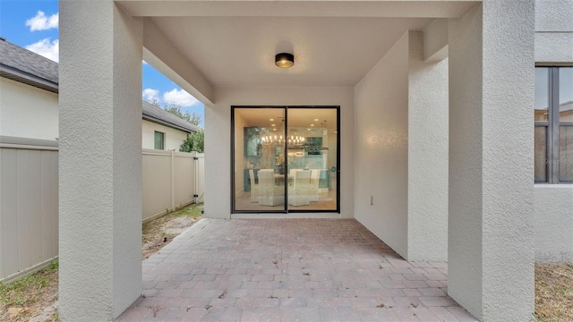 view of exterior entry featuring a patio