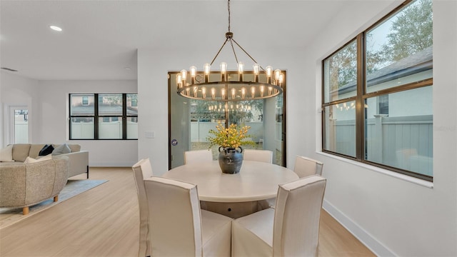 dining area featuring an inviting chandelier, light hardwood / wood-style floors, and plenty of natural light