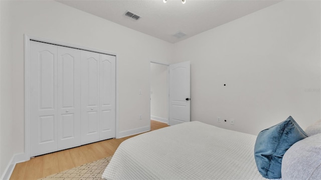 bedroom with a closet and hardwood / wood-style floors