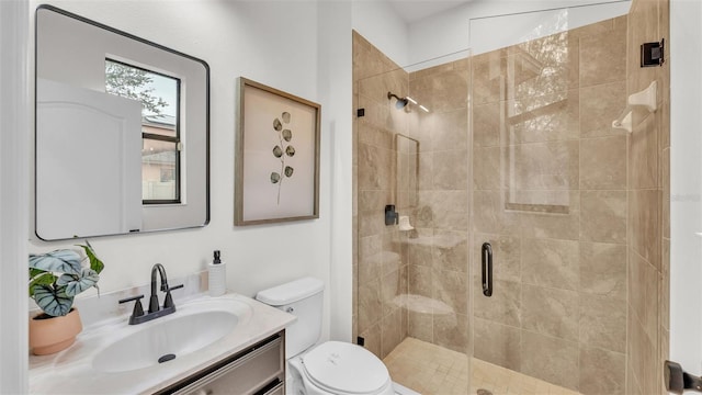 bathroom with a shower with shower door, toilet, and vanity