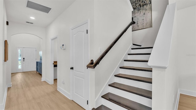 stairway with hardwood / wood-style floors