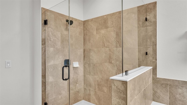 bathroom with a shower with door