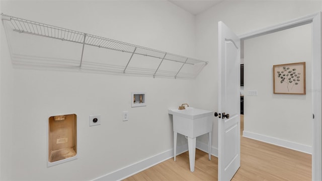 washroom featuring hookup for an electric dryer, hookup for a washing machine, and hardwood / wood-style flooring