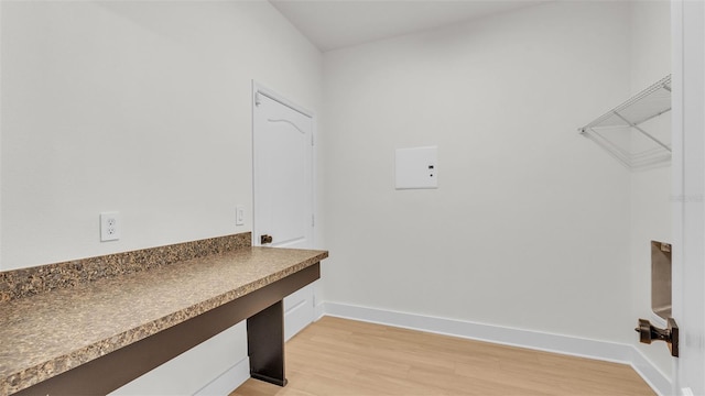 clothes washing area featuring light wood-type flooring