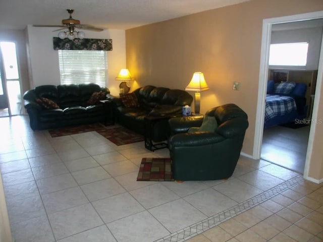 tiled living room featuring ceiling fan