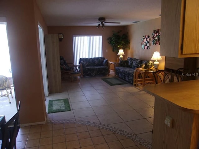 living room with light tile patterned floors and ceiling fan