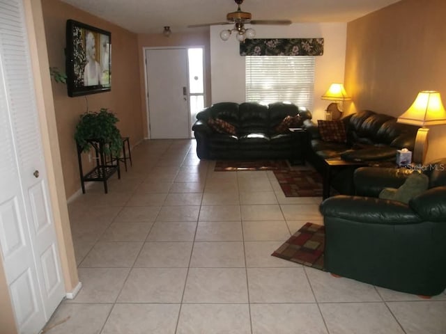 tiled living room featuring ceiling fan