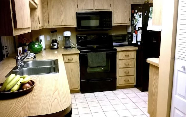 kitchen featuring black appliances, light tile patterned flooring, sink, and light brown cabinetry