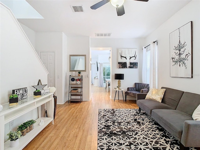 living room featuring hardwood / wood-style floors and ceiling fan